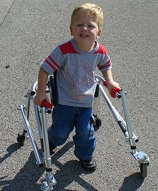 CP sufferers usually need special equipment such as a walker to aid them in walking as seen in this child.